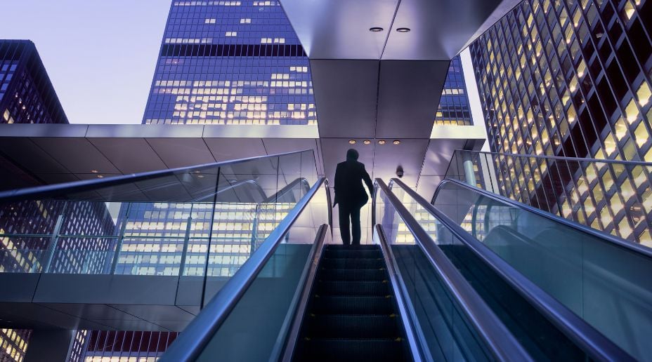 man at the top of the escalator