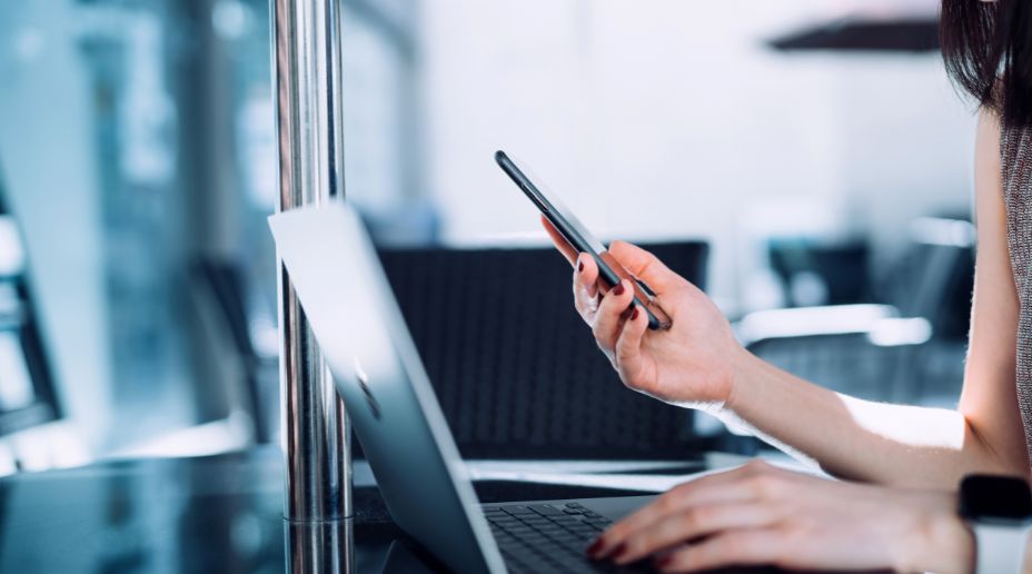 woman with phone and laptop