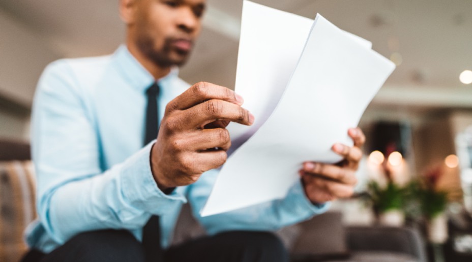 man looking through papers