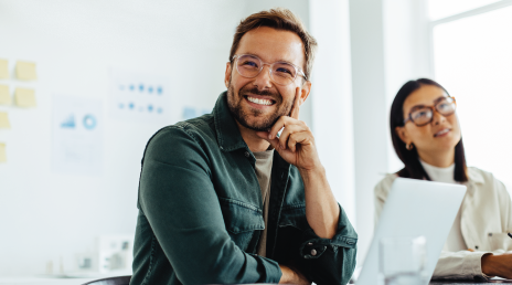 man smiling in a meeting