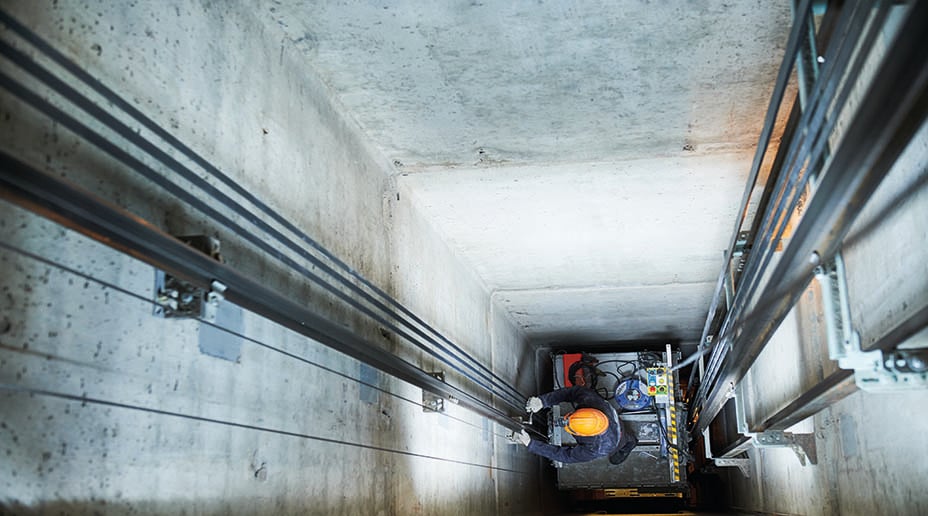 man working inside lift