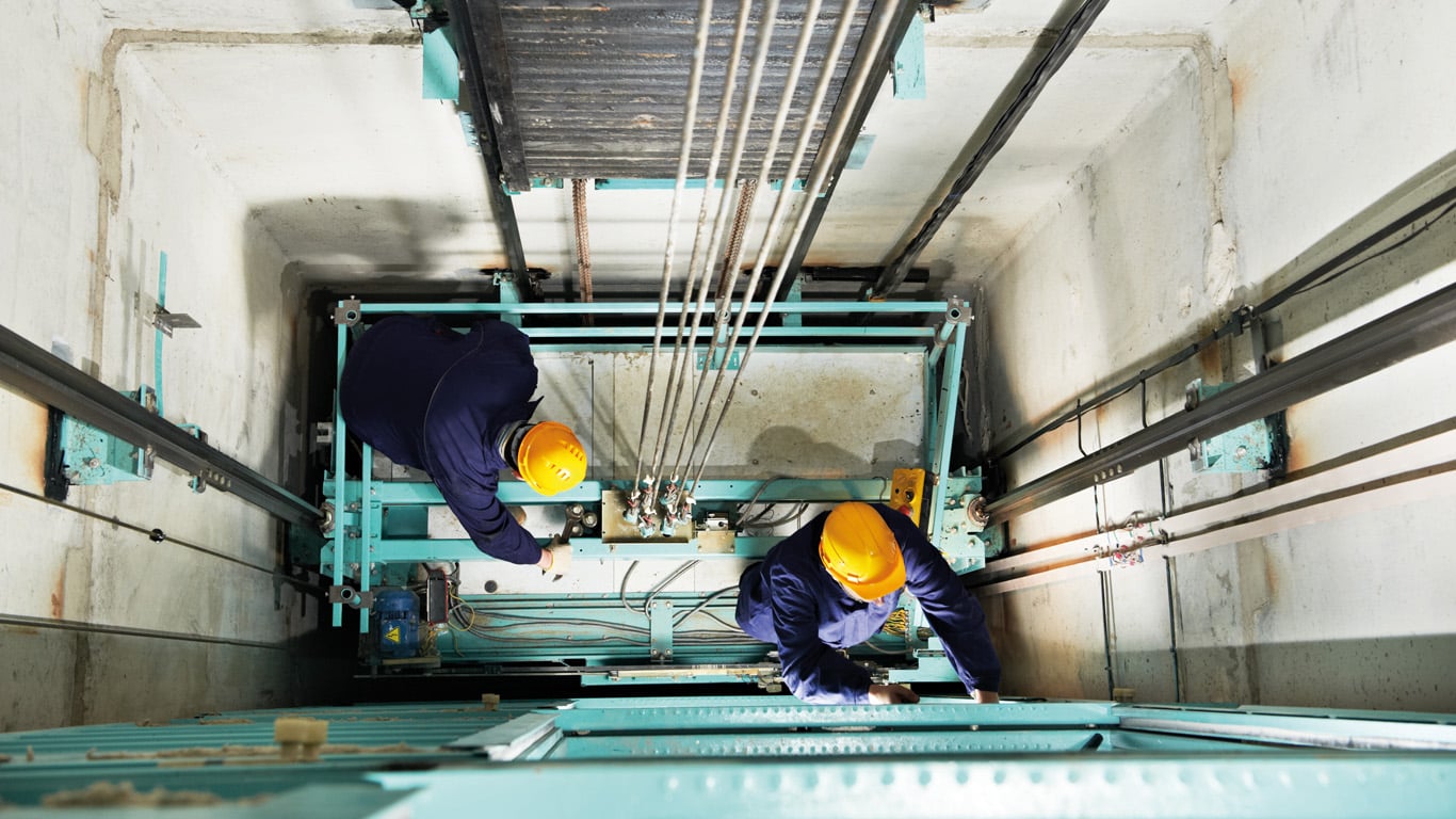 men in a lift shaft