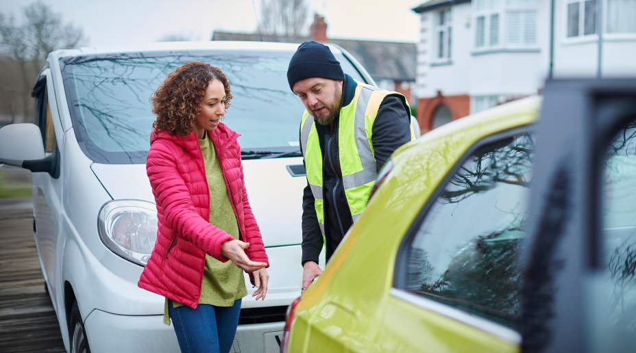 man and woman looking at car