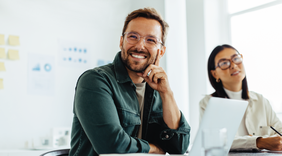 man smiling in a meeting