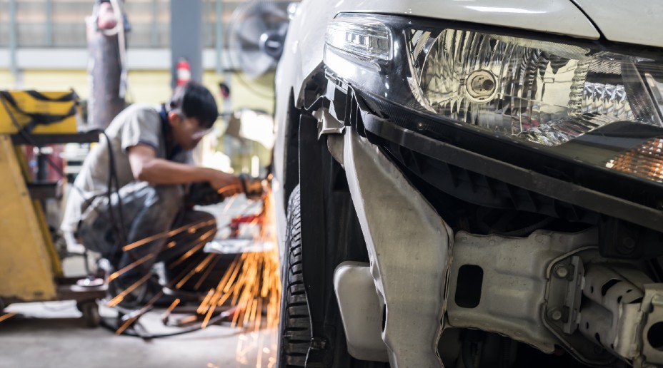 man repairing car in workshop